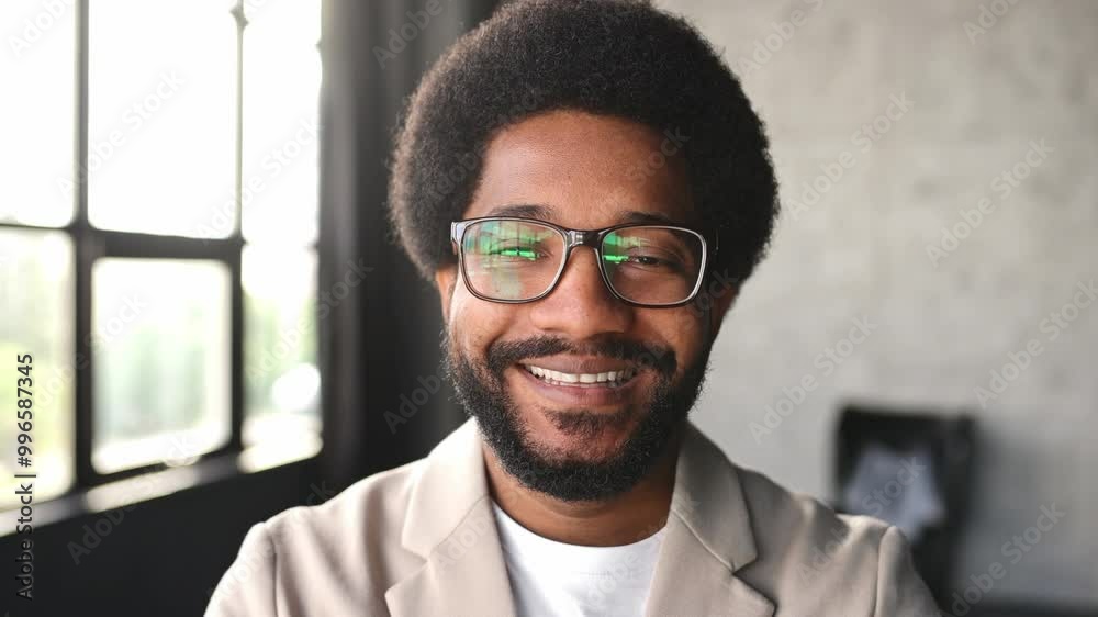A young Brazilian businessman in suit and glasses smiling, radiating confidence and contentment. The photograph captures the modern professional's optimistic outlook and personable nature A young Brazilian businessman in suit and glasses smiling, radiating confidence and contentment. The photograph captures the modern professional's optimistic outlook and personable nature