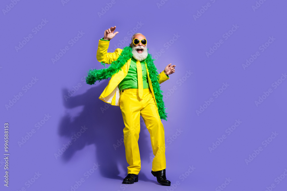 Full size photo of elegant charismatic aged man have fun dance yellow suit isolated on violet color background Full size photo of elegant charismatic aged man have fun dance yellow suit isolated on violet color background