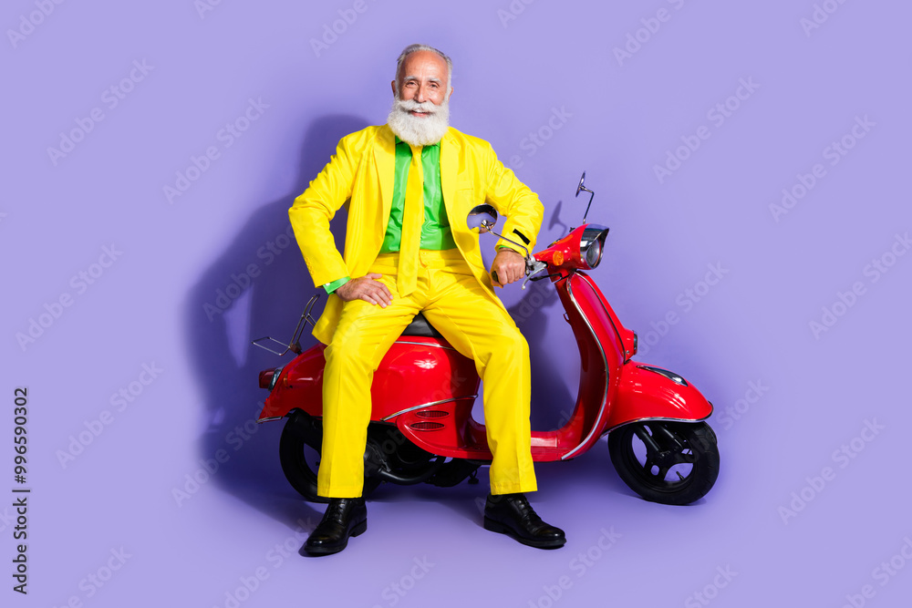 Photo of cheerful funny man pensioner wearing yellow trendy costume sitting scooter isolated on purple color background Photo of cheerful funny man pensioner wearing yellow trendy costume sitting scooter isolated on purple color background