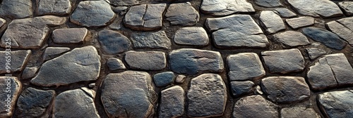 Cobblestone street texture, with uneven stones and weathered surfaces