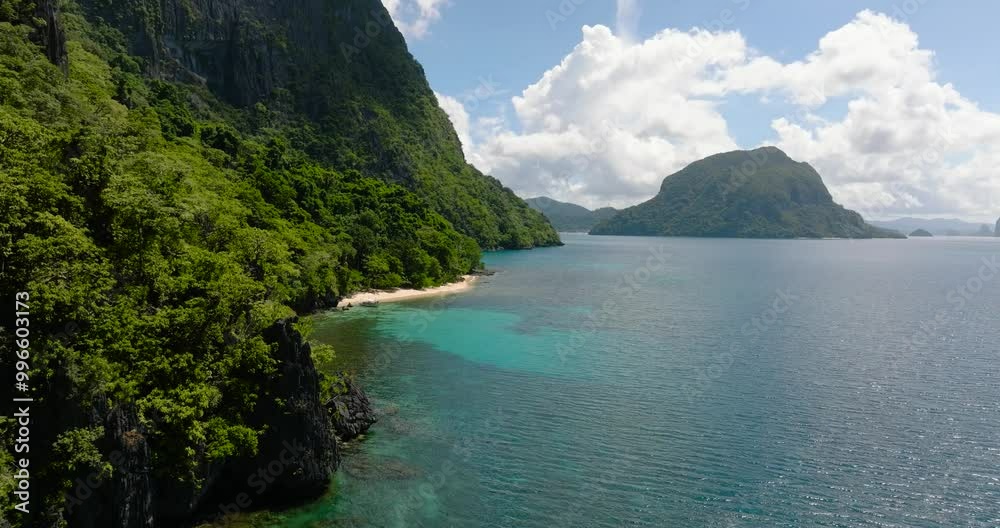 Tropical Island with white sandy beach. Blue sky and clouds. El Nido. Palawan, Philippines. Tropical Island with white sandy beach. Blue sky and clouds. El Nido. Palawan, Philippines.
