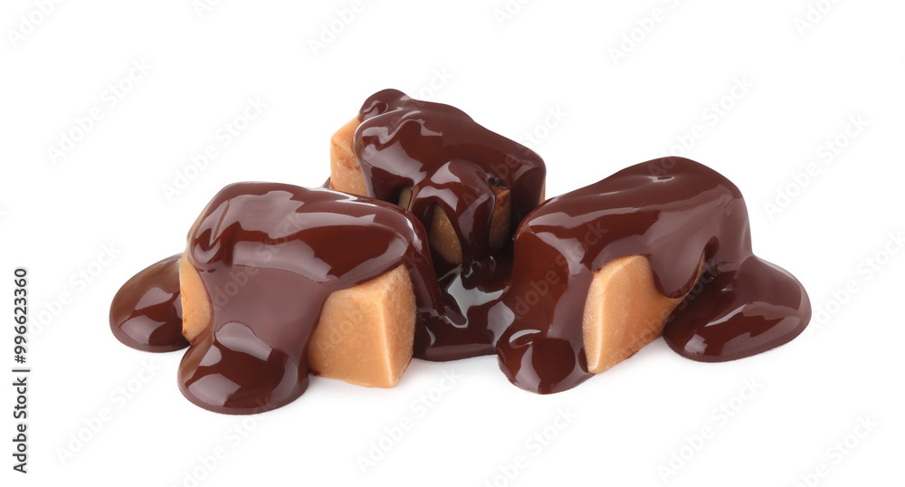 Fototapeta premium Delicious caramel candies with melted chocolate isolated on white