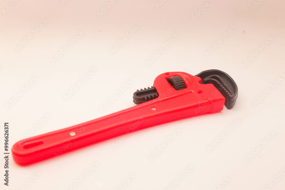 Toy craftsman tool in the shape of a Pipe Wrench on a white background Toy craftsman tool in the shape of a Pipe Wrench on a white background
