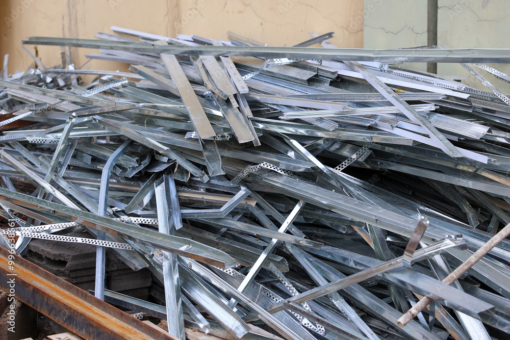 Metal scraps are piled high in an industrial yard