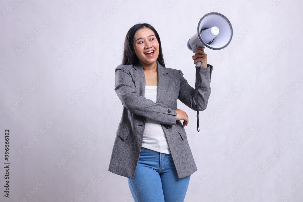 beautiful office girl asia screaming happy candid hugging holding megaphone loudspeaker wearing grey suit isolated on white background. for fashion, lifestyle, advertising, broadcast, shopping content beautiful office girl asia screaming happy candid hugging holding megaphone loudspeaker wearing grey suit isolated on white background. for fashion, lifestyle, advertising, broadcast, shopping content