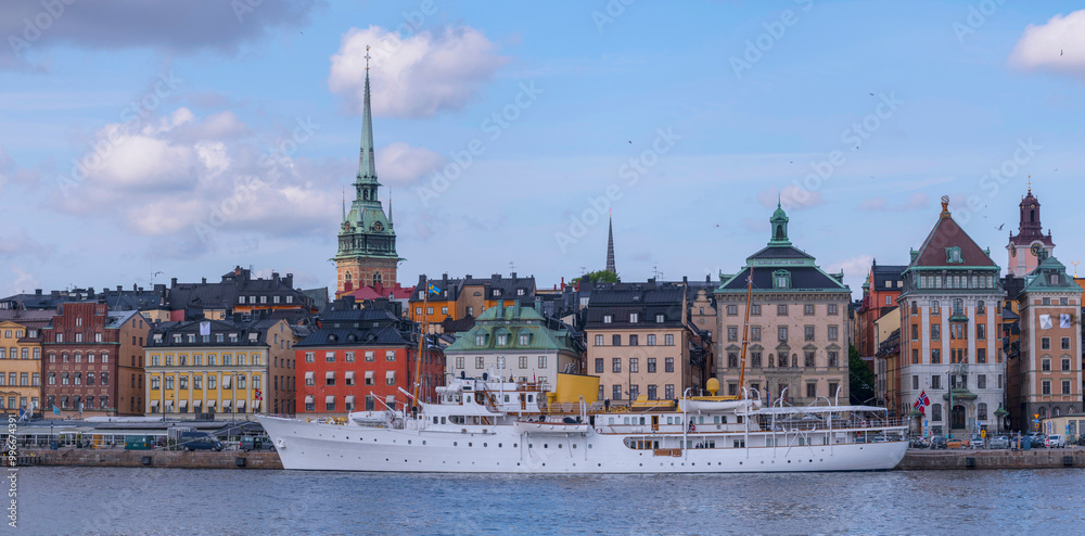Fototapeta premium Waterfront panorama, the old town Gamla Stan, the royal ship Norge with Norwegian royals visiting the Swedish queens 80 birthday, a sunny day in Stockholm