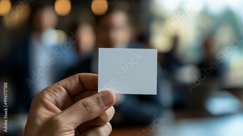 Hand Holding Blank Business Card with Blurred Background