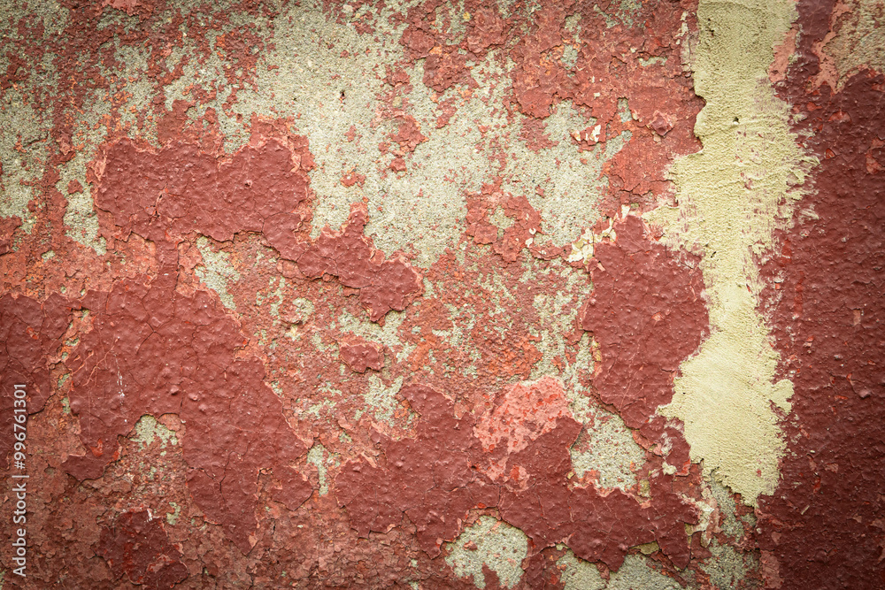 Layers of peeling paint create a captivating tapestry of colors on an old wall, illuminated by warm evening light. Layers of peeling paint create a captivating tapestry of colors on an old wall, illuminated by warm evening light.