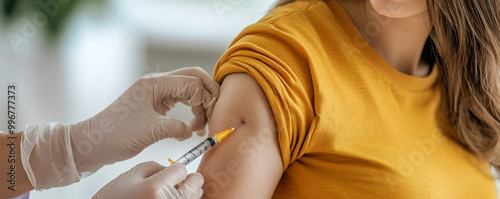 Close-up of a female arm being injected with a syringe for a medical procedure.	
