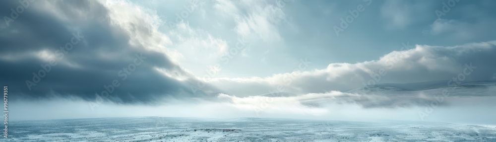 A cloudy sky with a snow covered field A cloudy sky with a snow covered field