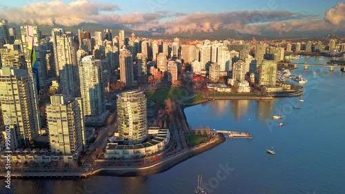 sunset over downtown vancouver in Canada with sun lights reflecting the bay and the building