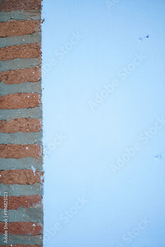 Blue wall with red bricks on the right side 