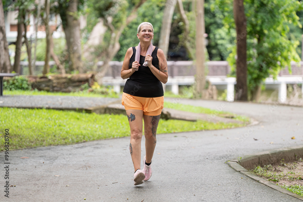 Active Elderly Woman Embracing Joyful Walking Routine in a Natural Park Setting Active Elderly Woman Embracing Joyful Walking Routine in a Natural Park Setting