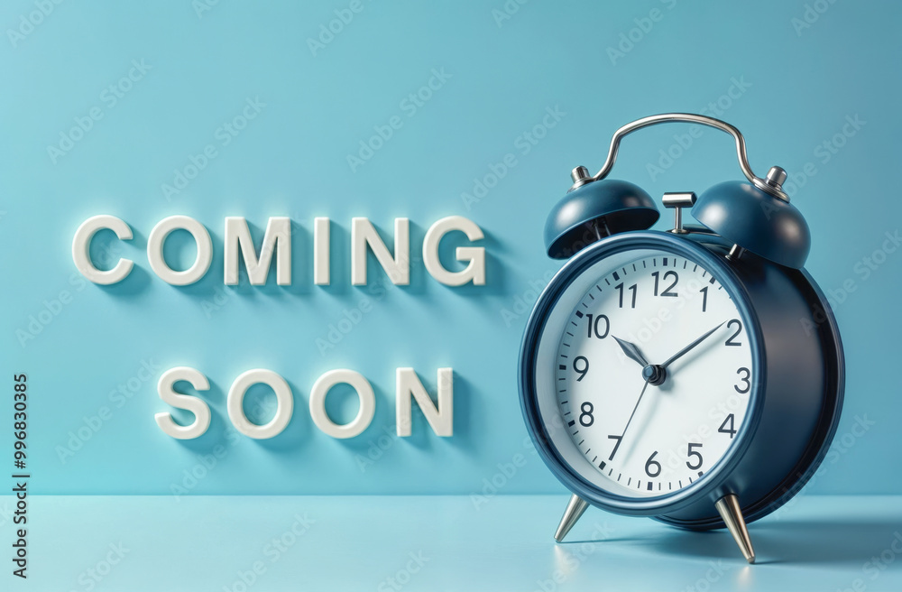 Coming soon text and alarm clock on blue background, business concept background Coming soon text and alarm clock on blue background, business concept background