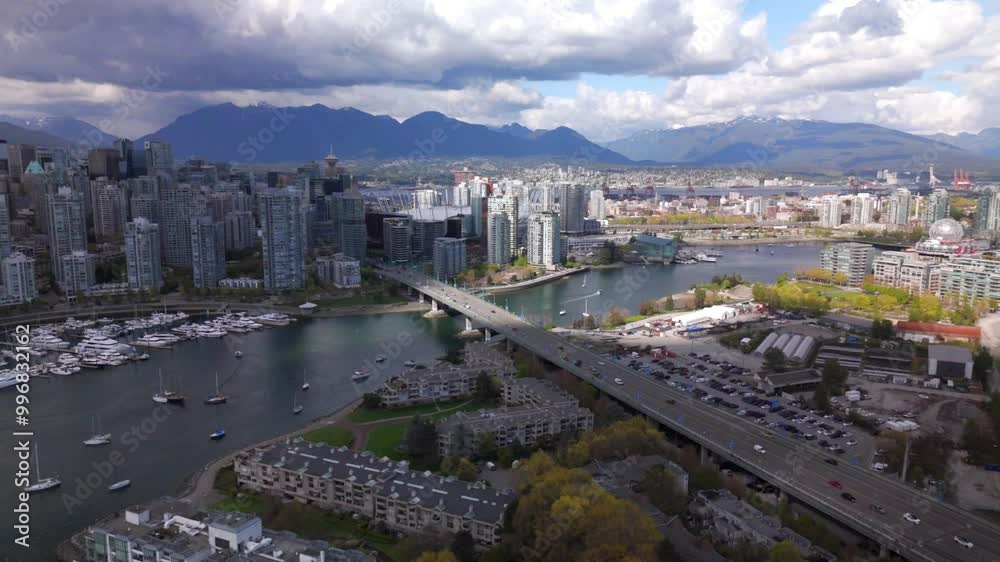 aerial view of downtown Vancouver in sunset showing the Science World, False Creek and the Rocky Mountains at distance aerial view of downtown Vancouver in sunset showing the Science World, False Creek and the Rocky Mountains at distance