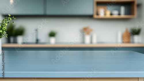 Kitchen with an empty blue countertop against a blurred background of a modern interior. Tabletop for product presentation. Clean mockup for food or laundry detergent, washing.