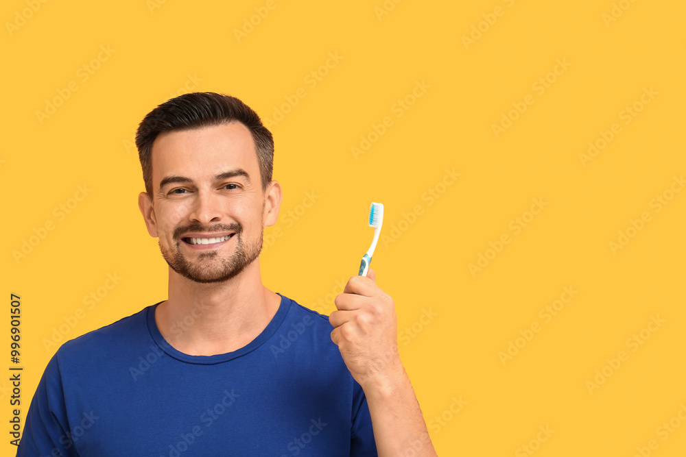 Handsome man with toothbrush on yellow background Handsome man with toothbrush on yellow background