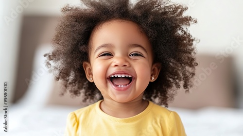 Wallpaper Mural Smiling Baby Girl with Big Curly Hair in Bright Yellow Dress Indoors Torontodigital.ca