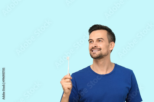 Handsome man with toothbrus...