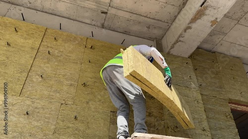 Installation of insulation on the facade of a building, live footage