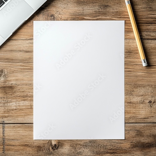 Blank White Paper with Pencil and Laptop on Wooden Desk