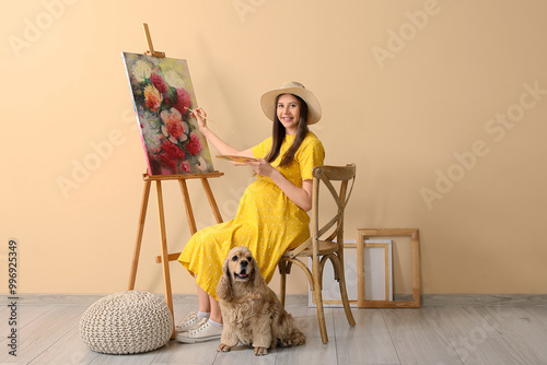 Young pregnant artist paint...
