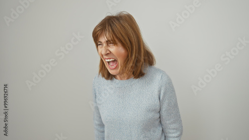 Quadro em tela A middle-aged woman in a blue sweater screams with a white background, portraying strong emotion