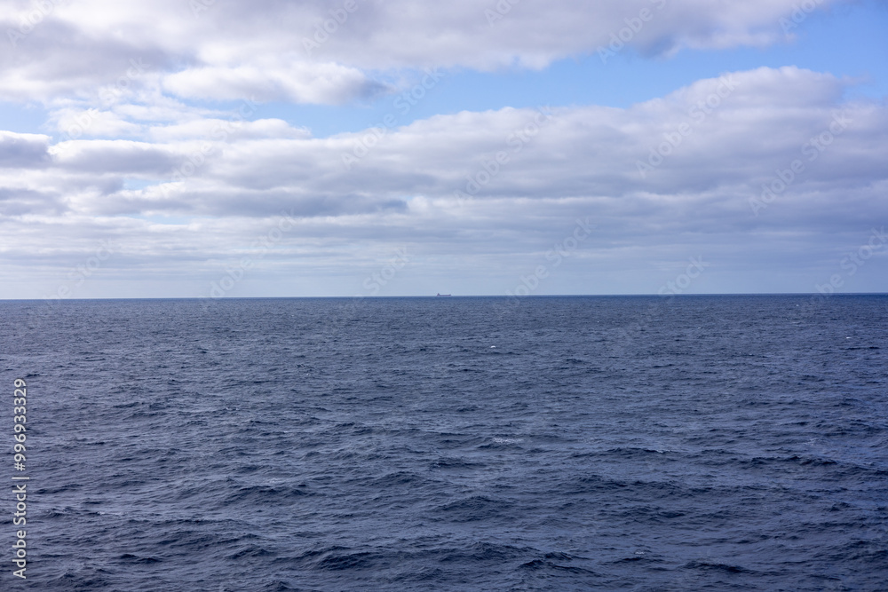 ocean and sea of clouds with a ship on the horizon ocean and sea of clouds with a ship on the horizon