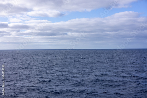 ocean and sea of ​​clouds with a ship on the horizon