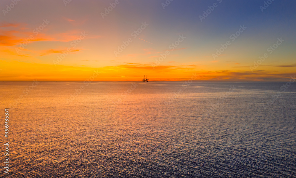 Obraz premium Southport, Merseyside, UK, September 16, 2024; Aerial view of the Oil Gas Platform off the coat of Southport with Stunning Sunset, Southport Merseyside