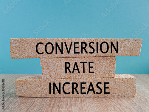 Conversion rate increase symbol. Concept words Conversion rate increase on brick blocks on a beautiful blue background, wooden table. Business Conversion rate increase concept.