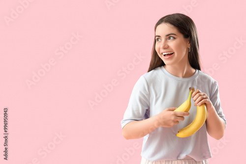Young woman with bananas on...