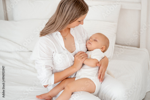 mom puts the baby to sleep hugging him before going to bed, healthy sleep together with the mother, the child sleeps in mom's arms