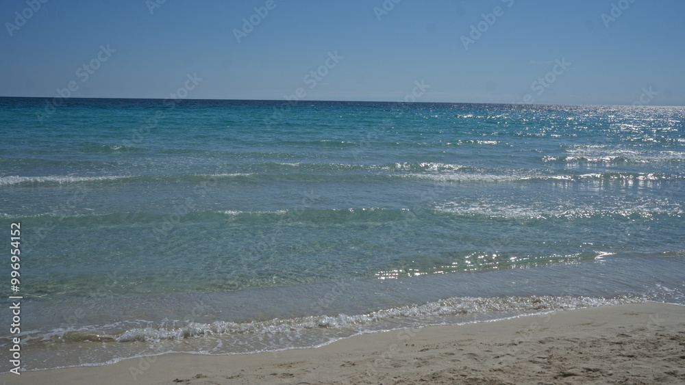 A scenic view of the clear turquoise mediterranean sea at porto cesareo beach in salento, puglia, italy on a sunny day. A scenic view of the clear turquoise mediterranean sea at porto cesareo beach in salento, puglia, italy on a sunny day.