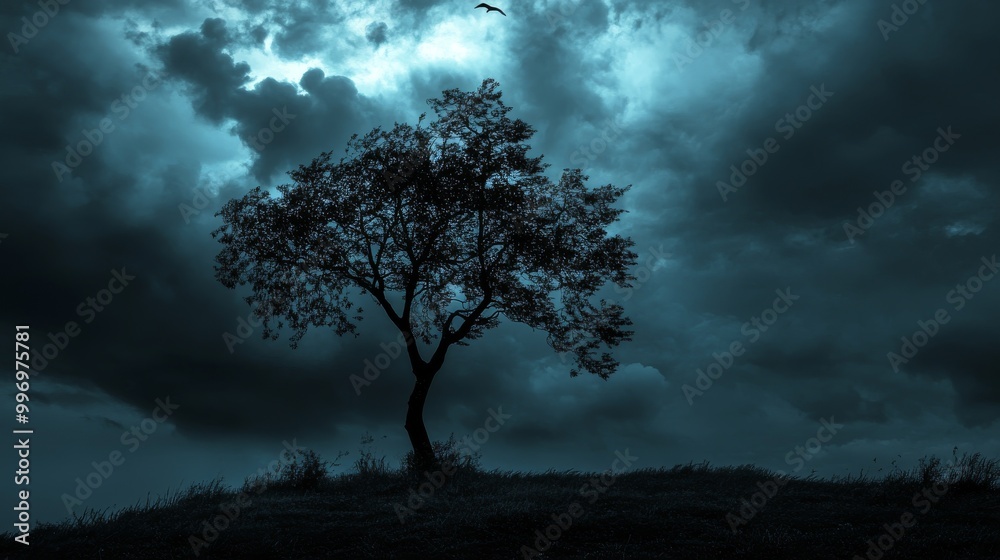 A stark, black tree stands out against a stormy sky, with dark clouds hanging overhead. A stark, black tree stands out against a stormy sky, with dark clouds hanging overhead.