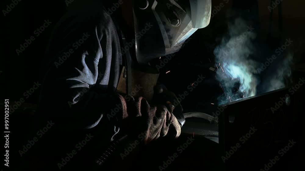 Close up of a welder welding in workshop. Close up of a welder welding in workshop.