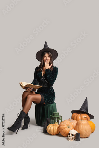 Young witch with spell book...