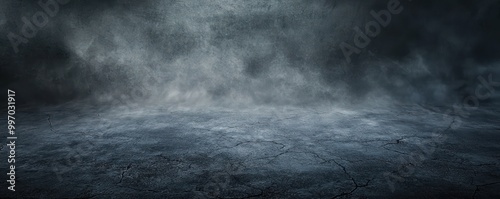 A textured dark concrete floor enveloped in mist or fog, creating an enigmatic and atmospheric abstract background. photo