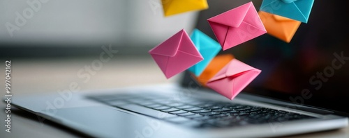 Close-Up Of Colorful Envelopes Above Laptop Keyboard