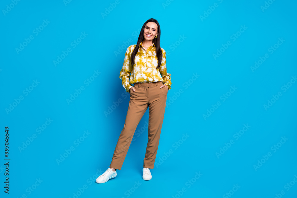 Photo of gorgeous lovely positive woman wear trendy outfit isolated on blue color background Photo of gorgeous lovely positive woman wear trendy outfit isolated on blue color background