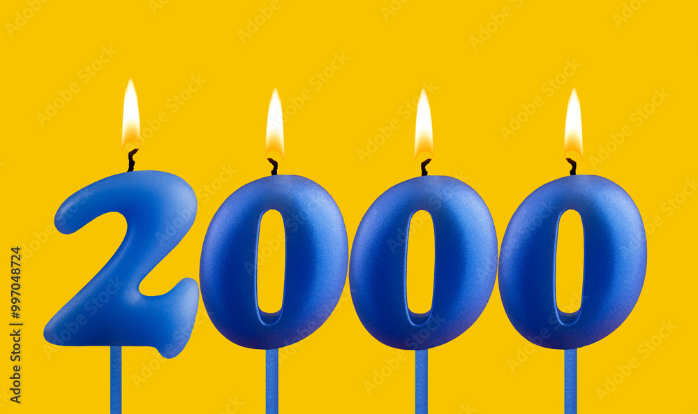 Blue birthday candle on yellow background - Number 2000