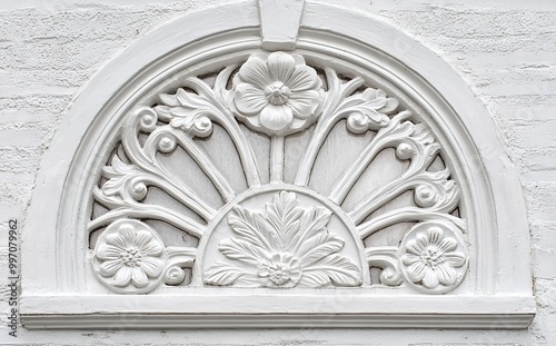 Walls plastered in white with a white floral relief.