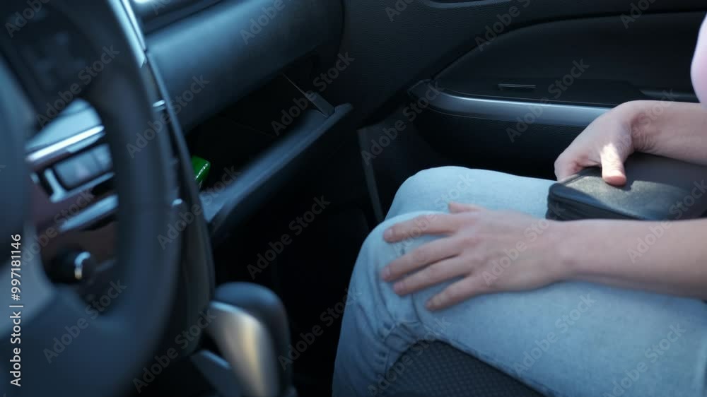 Save in compartment box in auto. A view of female things save the things into compartment box in the vehicle. Save in compartment box in auto. A view of female things save the things into compartment box in the vehicle.