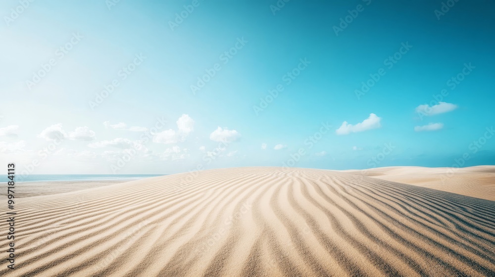 Naklejka premium The vast sand dunes stretch endlessly, their soft curves marked by gentle winds under a bright blue sky, embodying a serene desert landscape