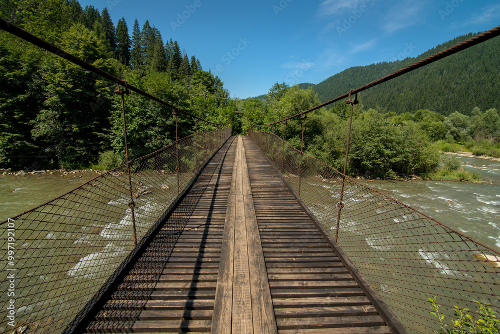suspension cable bridge over the Cheremosh River in the Carpathian Mountains, Ukraine suspension cable bridge over the Cheremosh River in the Carpathian Mountains, Ukraine