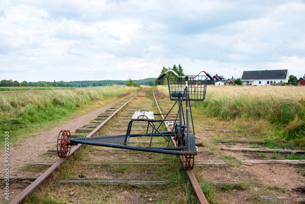 A single railway bike (draisine cycling) on the tracks in Klippan, Sweden A single railway bike (draisine cycling) on the tracks in Klippan, Sweden