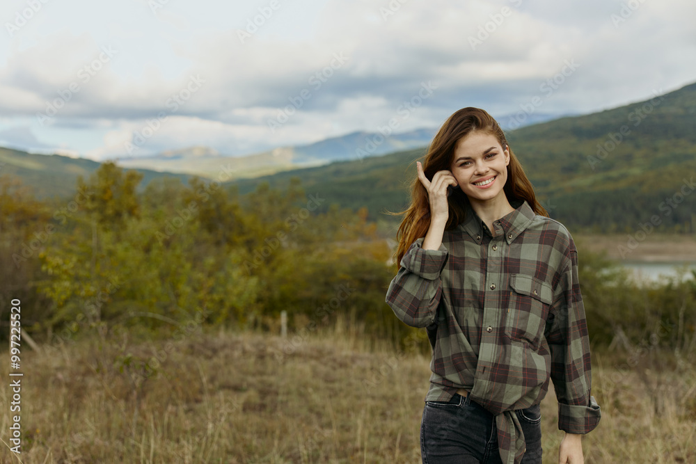 A professional businesswoman wearing a plaid shirt making a business call in a picturesque field A professional businesswoman wearing a plaid shirt making a business call in a picturesque field