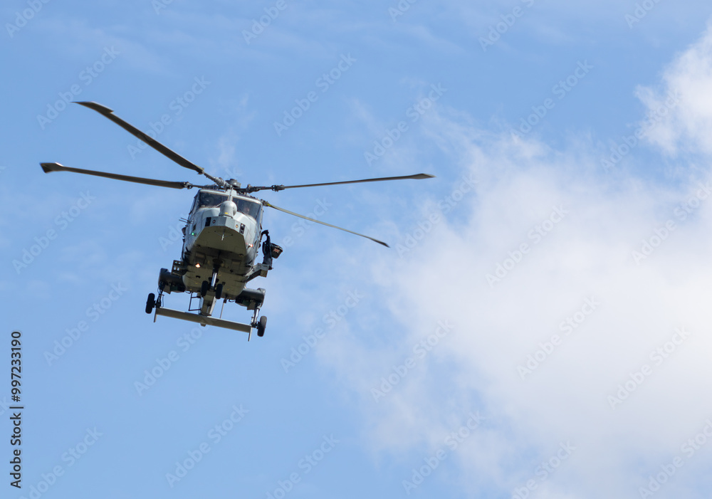 British army AgustaWestland ZZ393 AW159 Wildcat AH1 helicopter flying low level over Salisbury plain on a clear summers day British army AgustaWestland ZZ393 AW159 Wildcat AH1 helicopter flying low level over Salisbury plain on a clear summers day