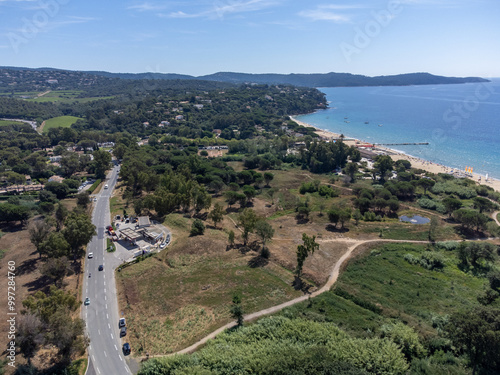 Aerial view on boats, crystal clear blue water of Plage du Debarquement white sandy beach near Cavalaire-sur-Mer and La Croix-Valmer, summer vacation on French Riviera, Var, France