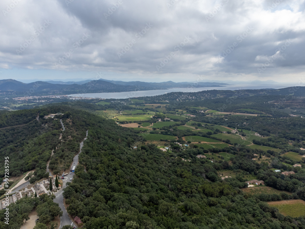 Obraz premium Aerial view on green hills, houses, gulf of saint-tropez, Gassin village, vineyards, Provence, Var, France